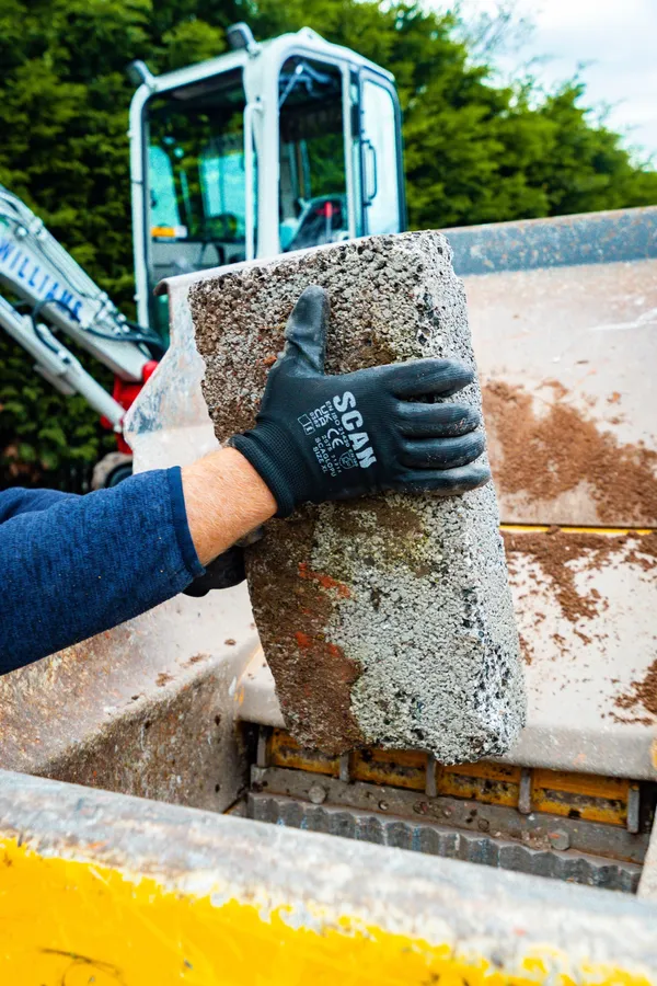 Concrete block held over the crusher jaw
