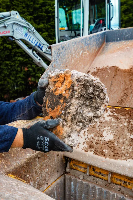 Lump of concrete being fed into the crusher jaw