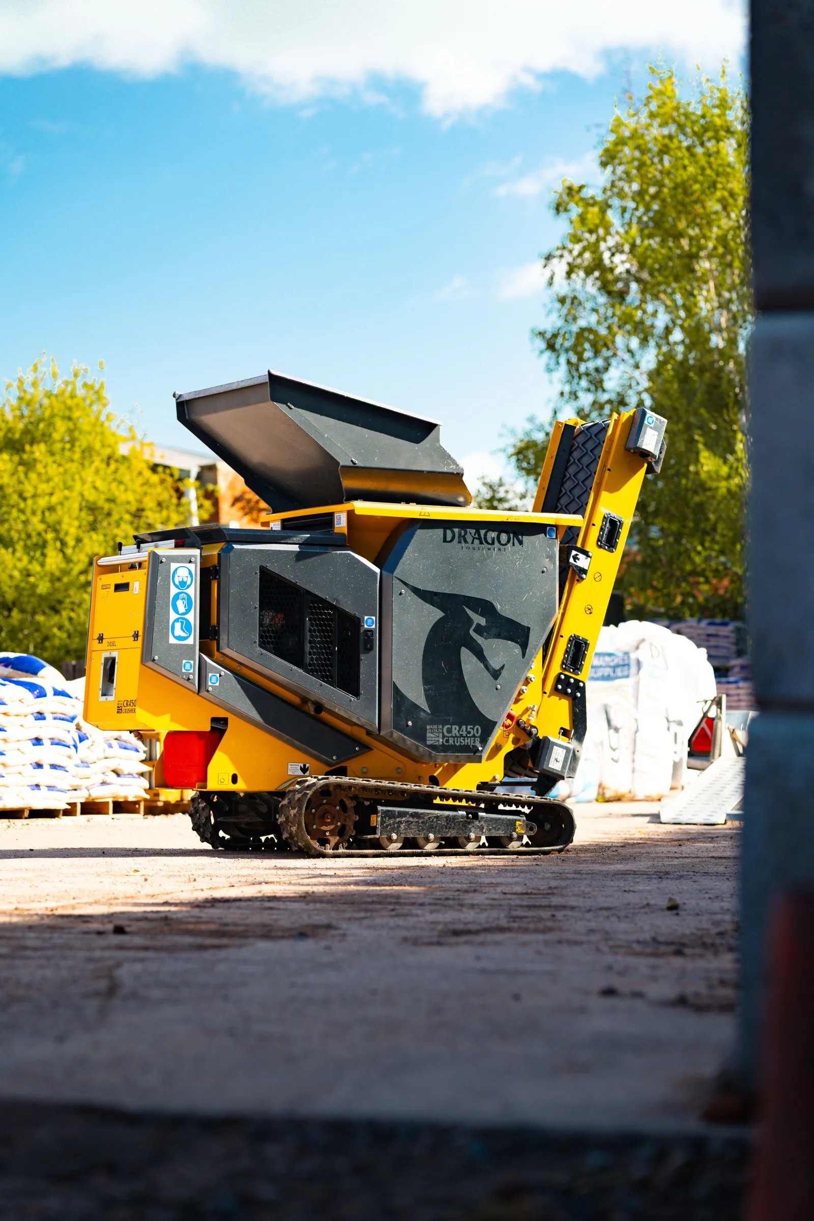Yellow Dragon Equipment CR450 tracked crusher standing in a yard under a blue sky