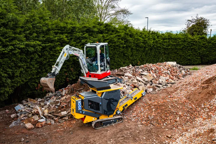 CR450 crushing on site with a mini excavator loading