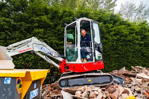 Mini excavator and CR450 crusher working a site together
