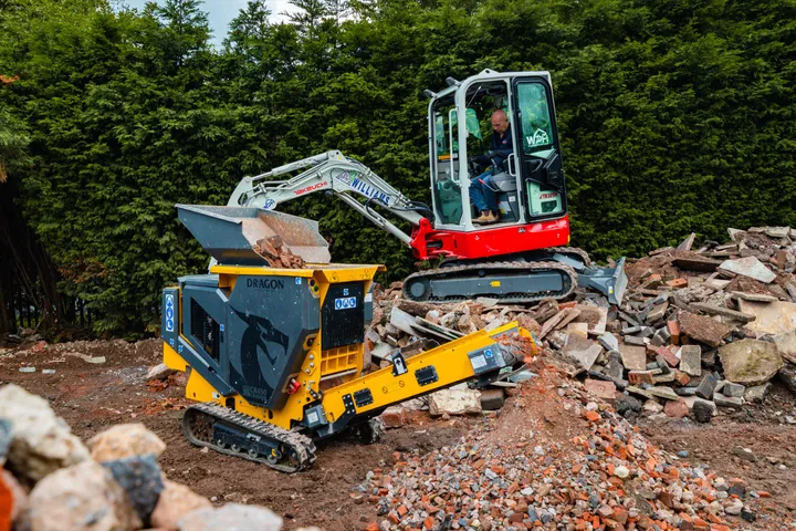 Mini excavator tipping rubble into the CR450 hopper