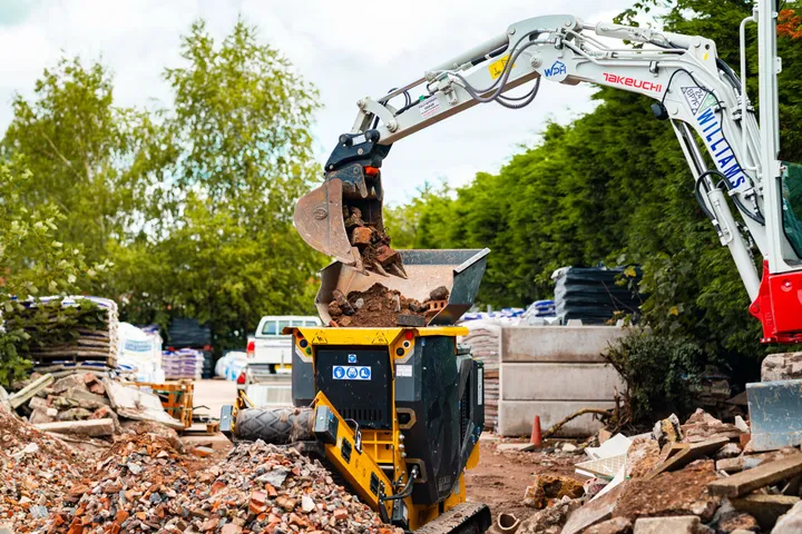 Mini excavator loading the CR450 from the side